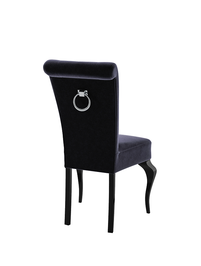 Elegant upholstered chair made of black velvet with silver ring handle and curved legs.