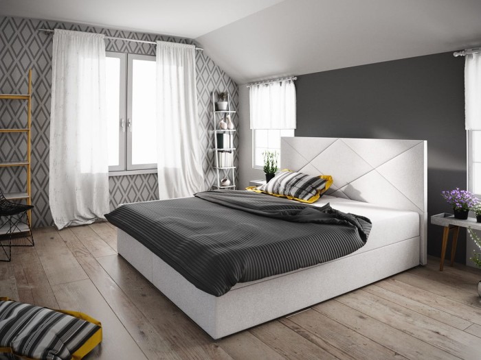Weißes Polsterbett mit Rautensteppung am Kopfteil und grauer Bettwäsche im modernen Schlafzimmer.