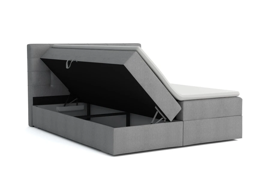 Graues Boxspringbett mit aufklappbarem Bettkasten und Stauraum für Bettwäsche.