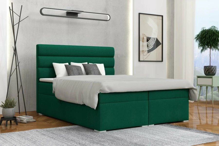 Dunkelgrünes Boxspringbett mit gestepptem Kopfteil in einem modern eingerichteten Zimmer.