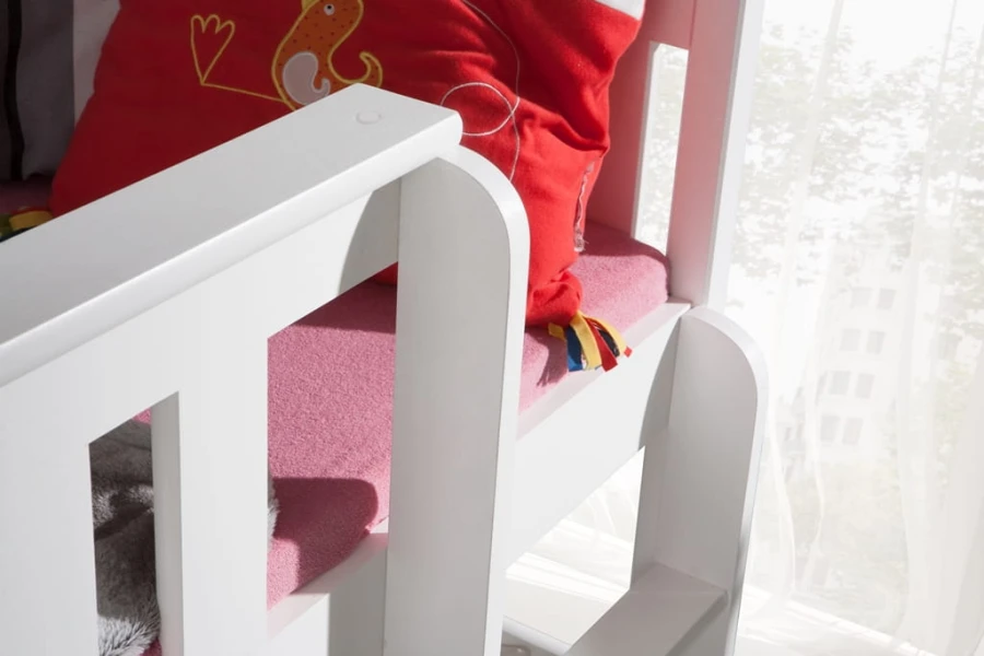 Detail view of the safely rounded edges and the ladder posts on the white bunk bed.