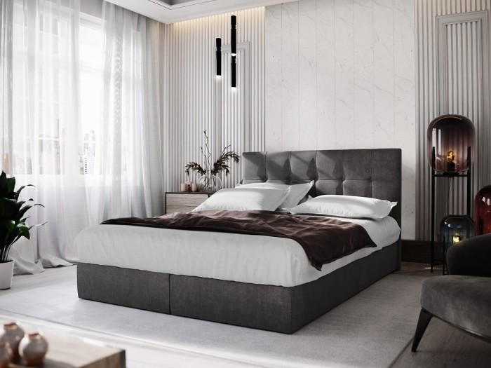 Modernes graues Polsterbett im Schlafzimmer mit weißer Bettwäsche und stilvoller Dekoration.