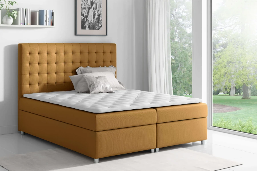 Senfgelbes Boxspringbett mit modernem Polsterkopfteil