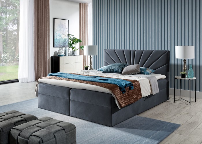 Graues Boxspringbett mit dekorativem Fächer-Kopfteil in einem hellen, modernen Zimmer.