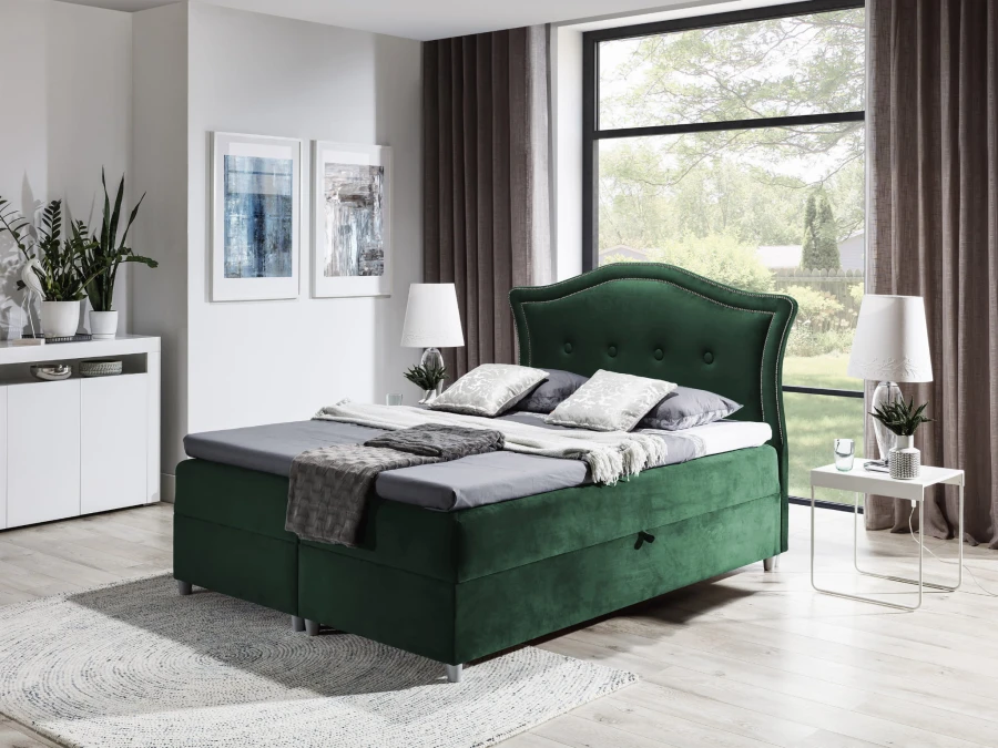 Dunkelgrünes Samt-Boxspringbett mit gestepptem Kopfteil und Bettkasten.