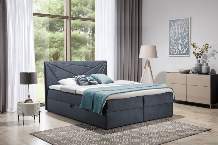 Dunkelgraues Boxspringbett mit geometrischem Muster am Kopfteil in modernem Schlafzimmer.