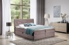 Modernes taupefarbenes Boxspringbett mit geometrisch gestepptem Kopfteil in hellem Schlafzimmer.