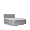 Hellgraues Boxspringbett mit Topper und dekorativem Kopfteil freigestellt auf weißem Hintergrund.