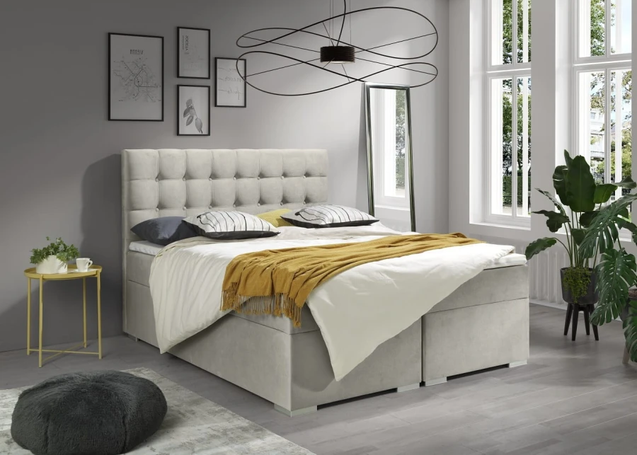 Modernes Boxspringbett in Beige mit senfgelber Decke und stilvoller Deko.