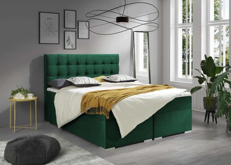 Grünes Boxspringbett mit gestepptem Kopfteil im modern eingerichteten Schlafzimmer.
