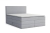 Modernes hellgraues Boxspringbett mit Stauraumfunktion und schlichtem Kopfteil auf weißem Hintergrund.