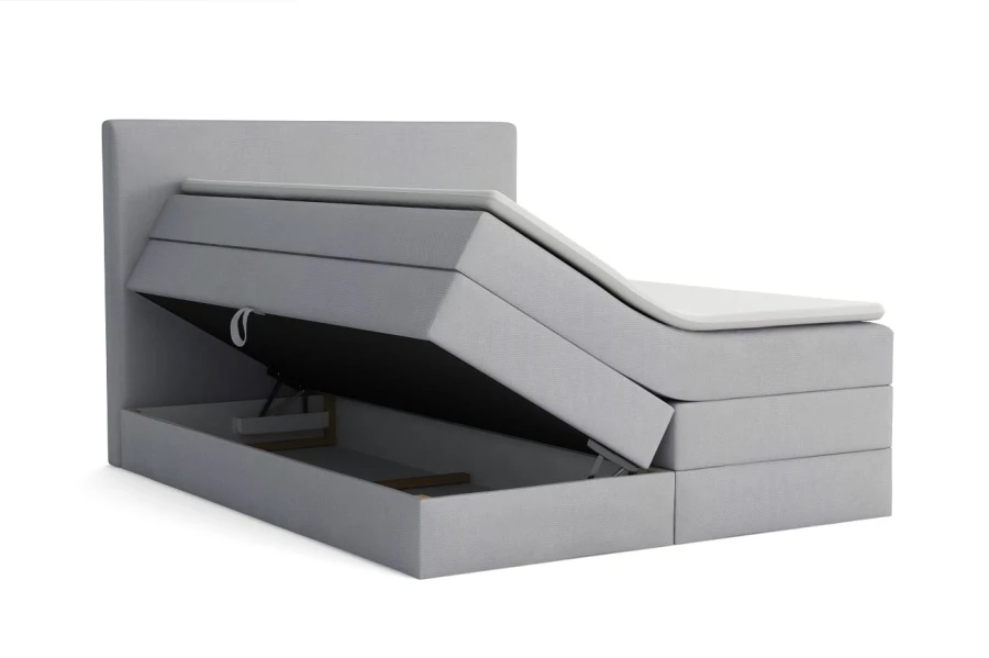 Hellgraues Boxspringbett mit funktionalem Stauraum und offenem Bettkasten.