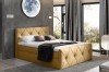 Modernes Boxspringbett in Senfgelb mit Rautensteppung und Kopfteil in stilvollem Schlafzimmer.