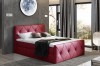 Elegantes weinrotes Boxspringbett mit gestepptem Kopfteil für exklusives Schlafzimmer-Design.