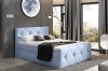 Hellblaues Boxspringbett mit dekorativem Rautenmuster und hochwertigem Stoff im Schlafzimmer.