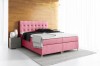 Rosa Boxspringbett mit gestepptem Kopfteil und hellen Holzfüßen in modernem Schlafzimmer.