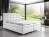 Elegantes weißes Boxspringbett in modernem Schlafzimmer mit großer Fensterfront.