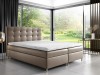 Stilvolles Boxspringbett in Taupe mit gepolstertem Kopfteil und Natur-Aussicht.
