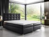 Schwarzes Boxspringbett aus Kunstleder im minimalistischen Schlafzimmer mit Waldblick.