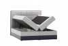 Graues Boxspringbett mit zwei aufgeklappten Bettkästen für viel Stauraum, isoliert auf Weiß.