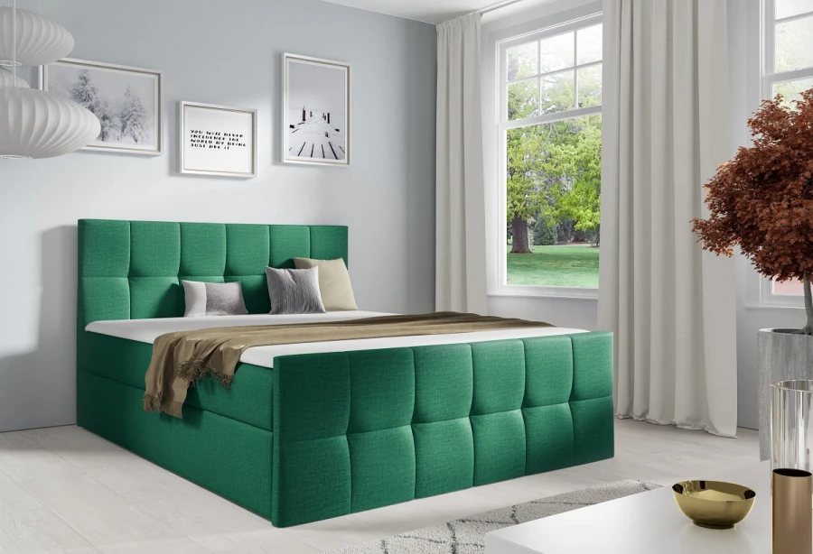 Grünes Boxspringbett mit gepolstertem Kopfteil in modernem Schlafzimmer.