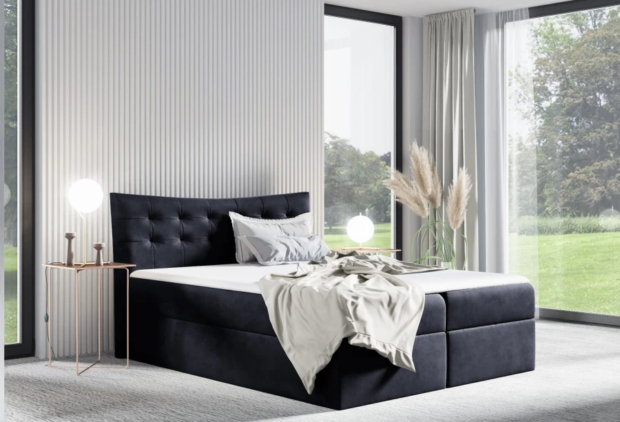 Dunkelblaues Boxspringbett aus Samt mit Steppung im hellen Schlafzimmer.