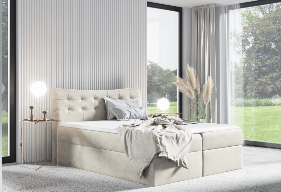 Modernes Boxspringbett in Beige mit gestepptem Kopfteil in hellem Schlafzimmer.