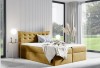 Elegantes senfgelbes Boxspringbett mit weichem Bezug und Steppung.