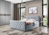 Hellblaues Samtbett mit eleganter Knopfheftung und modernem Design im Schlafzimmer.