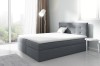 Graues Boxspringbett mit gestepptem Kopfteil in modernem Schlafzimmer mit Stadtblick.
