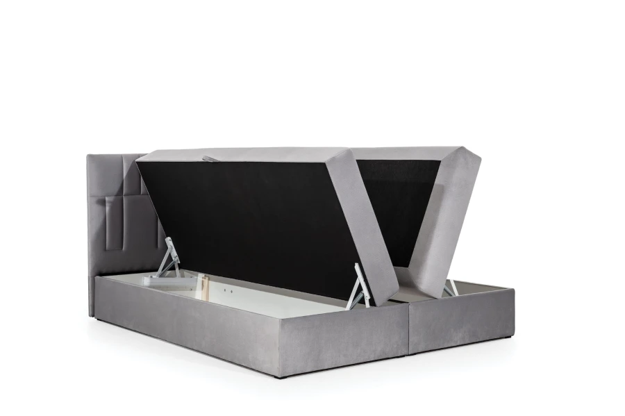 Graues Boxspringbett mit seitlich klappbarem Bettkasten und robustem Hebemechanismus.