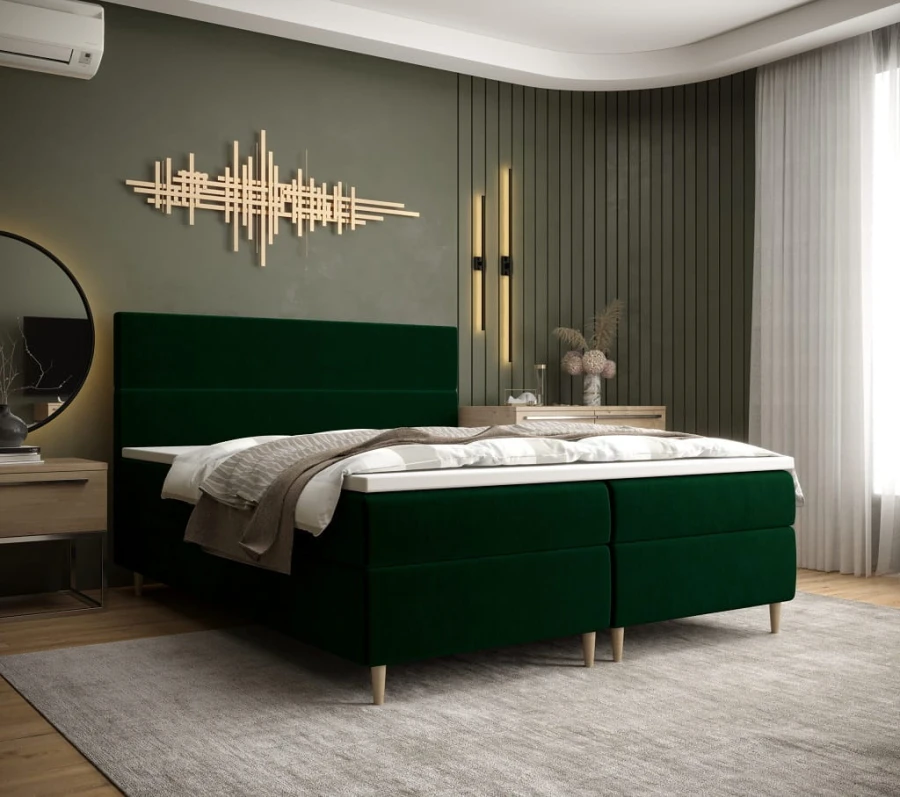 Elegantes dunkelgrünes Boxspringbett im modern eingerichteten Schlafzimmer