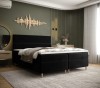 Schwarzes Boxspringbett in modernem Schlafzimmer mit grüner Wand und goldener Dekoration