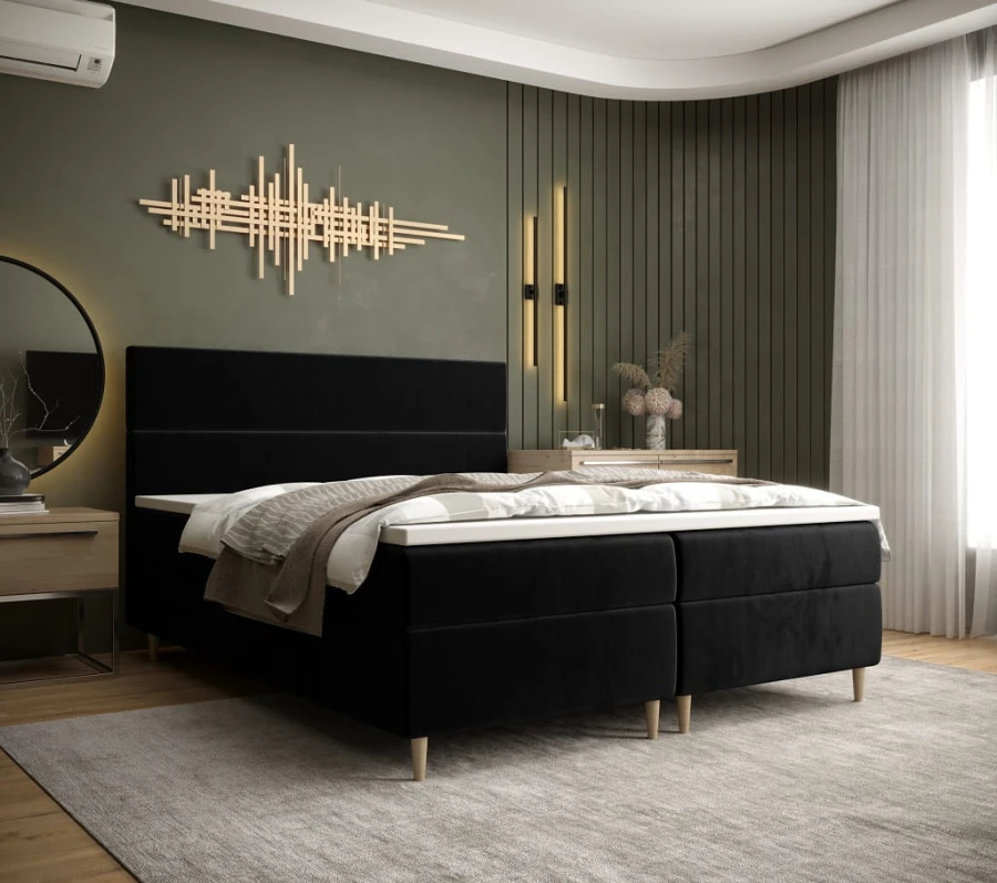 Schwarzes Boxspringbett in modernem Schlafzimmer mit grüner Wand und goldener Dekoration
