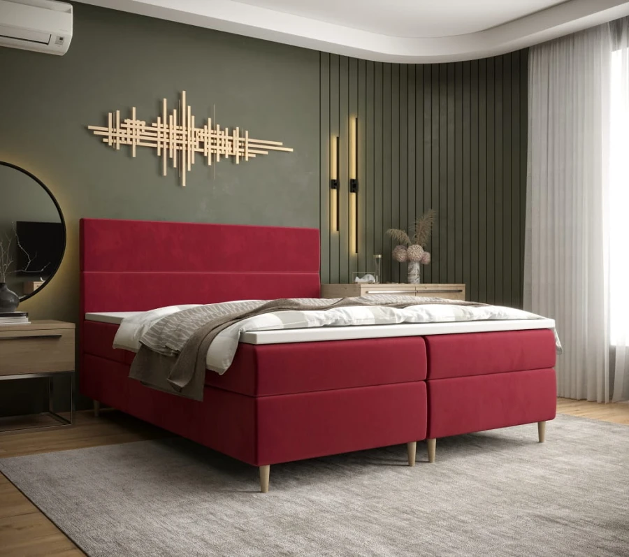 Rotes Boxspringbett in stilvollem Schlafzimmer mit moderner Wanddekoration