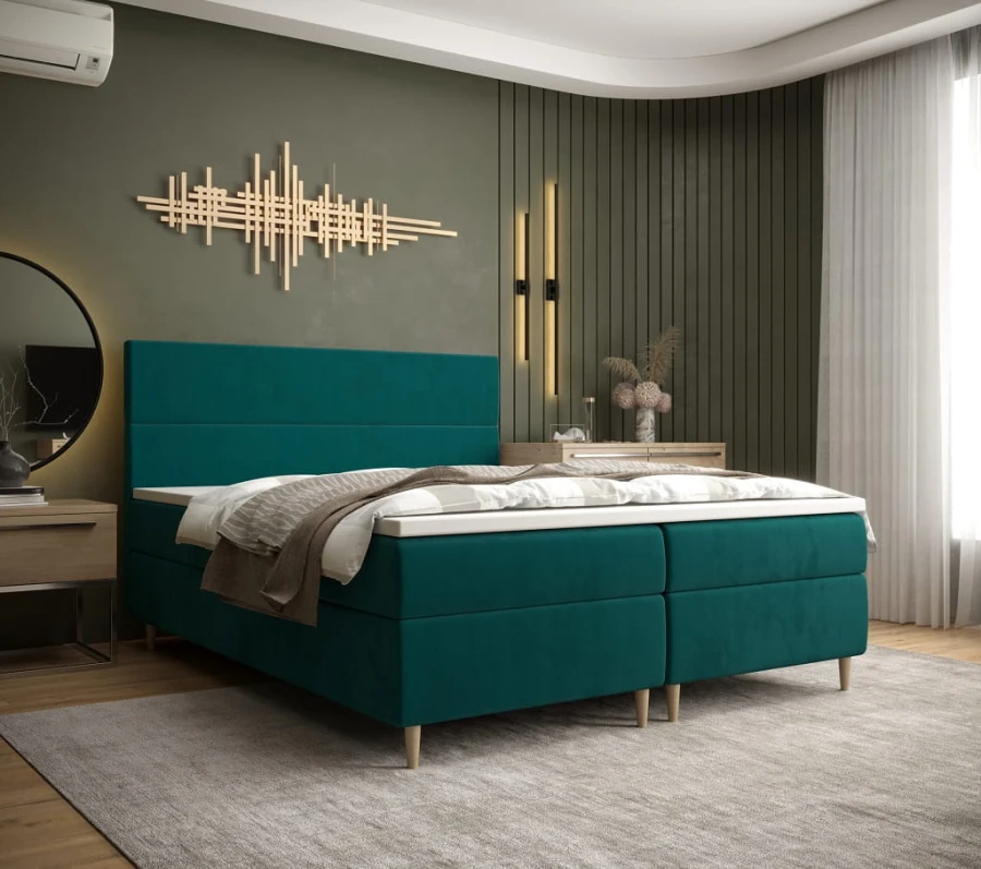 Modernes Boxspringbett in Türkis im stilvoll eingerichteten Schlafzimmer