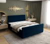 Elegantes Boxspringbett in Dunkelblau passend zu modernem Interieur
