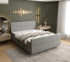 Graues Boxspringbett mit schlichtem Kopfteil für ein modernes Schlafzimmer