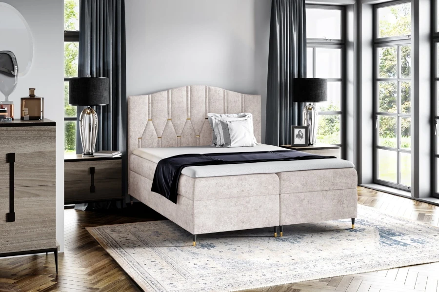 Helles Boxspringbett in Creme-Beige mit hochwertigem Textilbezug und modernem Design.