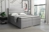 Hellgraues Boxspringbett mit horizontal gestepptem Kopfteil in modernem Schlafzimmer.