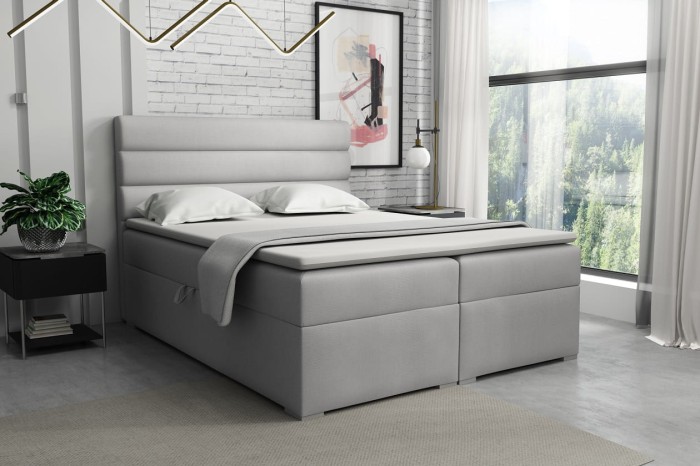 Boxspringbett in Hellgrau mit horizontaler Steppung am Kopfteil für modernen Schlafkomfort.
