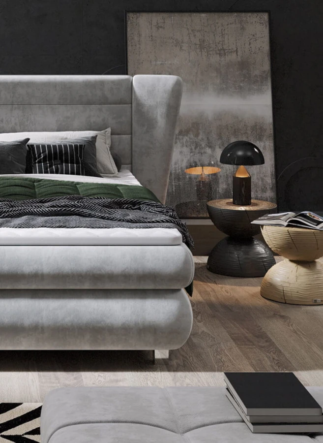 Graues Boxspringbett Detailansicht mit modernem Nachttisch und grüner Decke