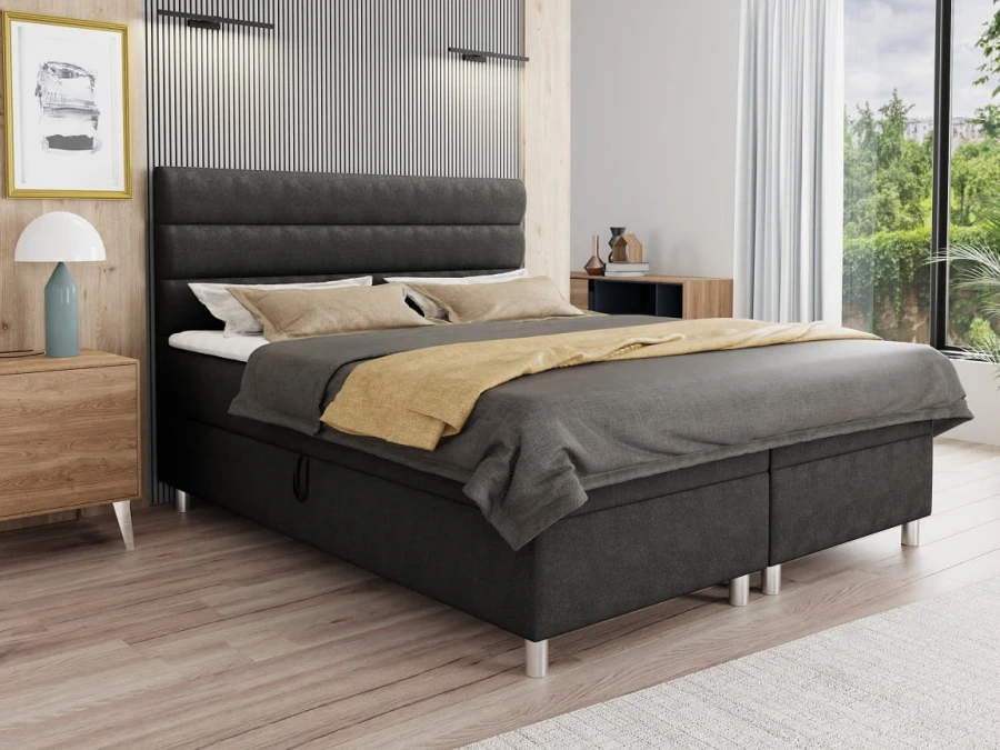 Anthrazitfarbenes Boxspringbett mit horizontal gestepptem Kopfteil in modernem Schlafzimmer.