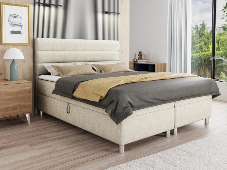 Beiges Boxspringbett mit gestepptem Kopfteil in modernem Schlafzimmer.