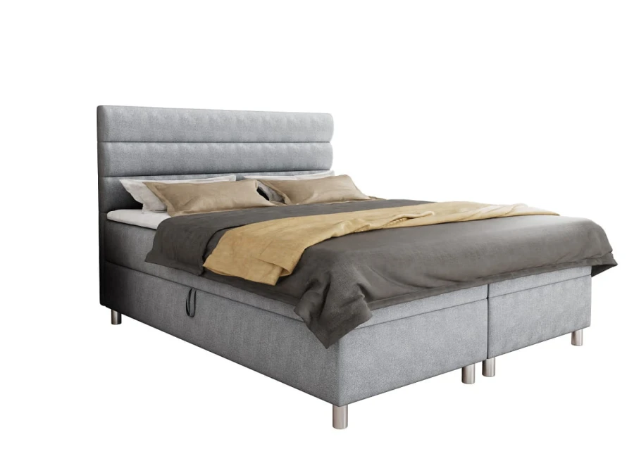 Modernes graues Boxspringbett mit Bettkasten auf weißem Hintergrund freigestellt.