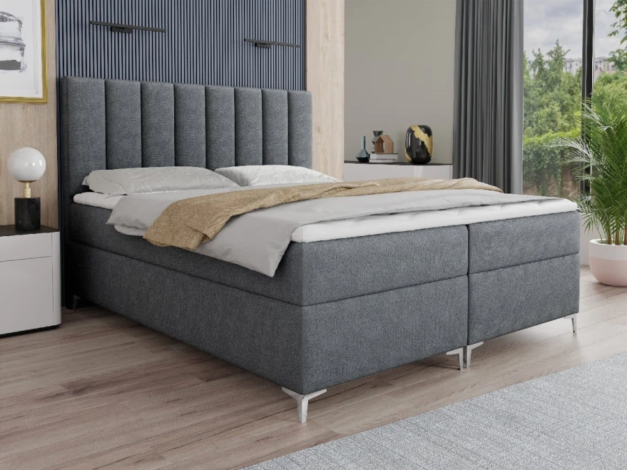 Dunkelgraues Boxspringbett mit stilvollem Kopfteil und gemütlichem Design für modernen Schlafkomfort.