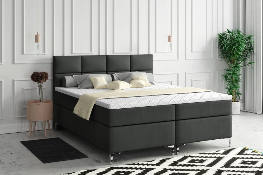 Modernes Boxspringbett in Anthrazit mit gestepptem Kopfteil im Schlafzimmer.