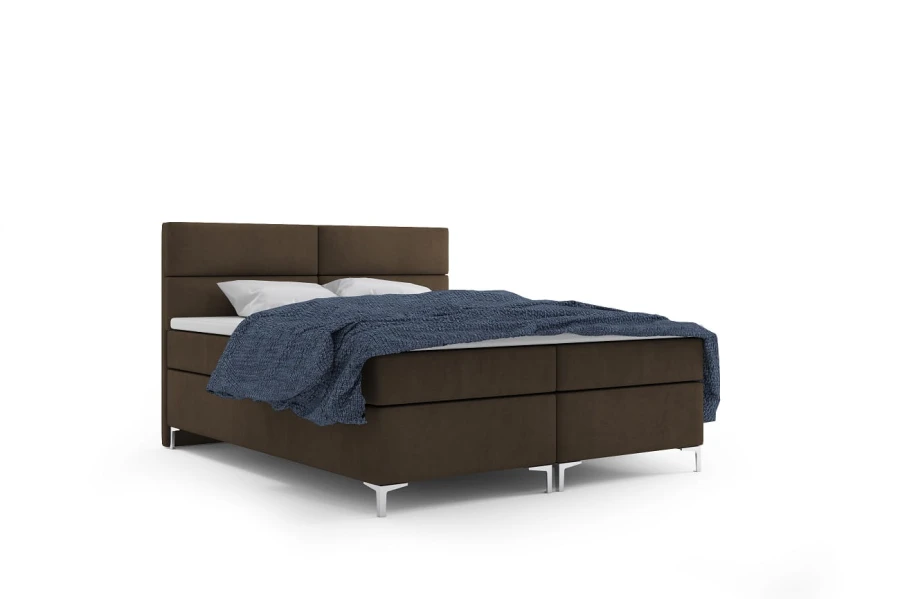 Boxspringbett in Braun mit blauer Decke, freigestellt auf weißem Hintergrund.