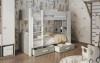 Bunk bed in white and grey wood look with shelf and bed bases in a playfully furnished children's room.