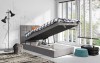 Graues Boxspring-Einzelbett mit offenem Bettkasten für praktischen Stauraum.